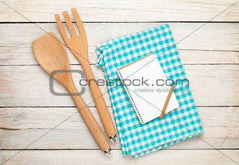 Kitchen utensil and notepad over wooden table