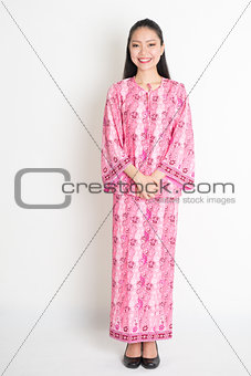 Asian woman in pink batik dress