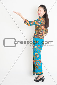 Asian female hand holding something
