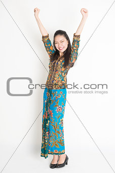 Happy Asian female arms up