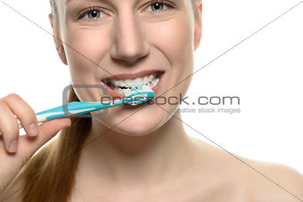 Attractive naked woman brushing her teeth