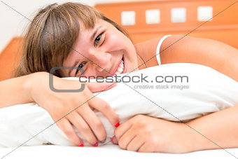 laughing beautiful girl resting in bed