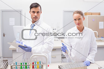 Scientists examining tubes