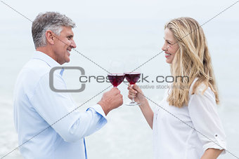 Happy couple smiling at each other and toasting