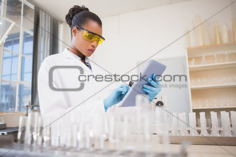 Concentrated scientist working with tablet