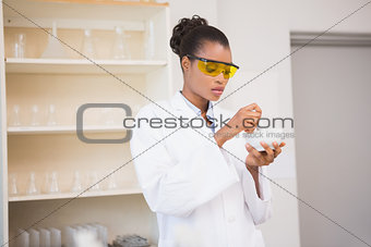 Concentrated scientist using pestle and mortar