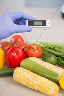 Scientist using device on vegetables