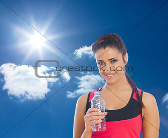 Composite image of fit woman holding water bottle