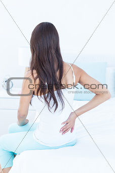 Brunette woman suffering from back pain