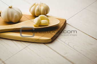 Garlic cloves and bulb on chopping board