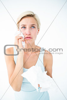 Crying pretty woman holding tissues