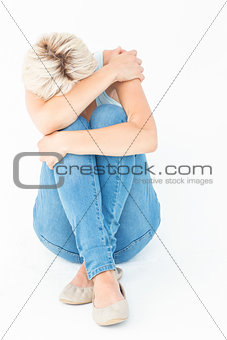 Depressed woman hiding her head
