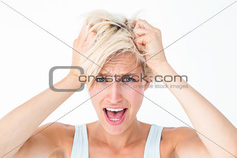 Stressed woman screaming and holding her head