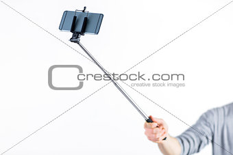 Casual man using a selfie stick