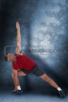 Composite image of fit man stretching his legs and arms