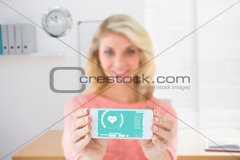 Composite image of pretty blonde showing her smartphone