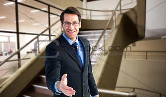 Composite image of hand being offered by smiling businessman