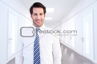 Composite image of smiling businessman standing with hands in pockets