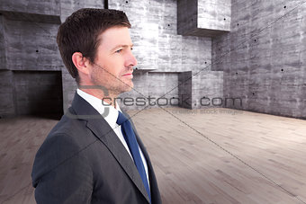 Composite image of handsome businessman looking away