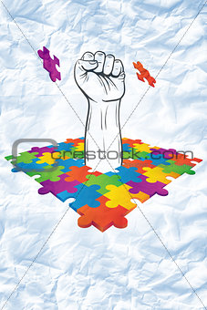 Composite image of hand punching through jigsaw