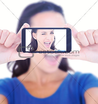 Composite image of pretty brunette winking at camera