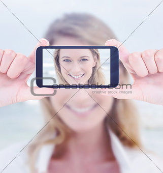 Composite image of hands holding smartphone