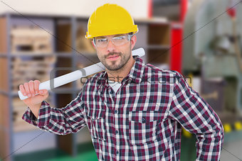 Composite image of handyman holding rolled up blueprint