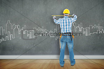 Composite image of rear view of construction worker using measure tape