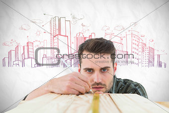 Composite image of carpenter marking on wooden plank
