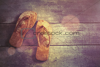 Pair of beach sandals on wood 