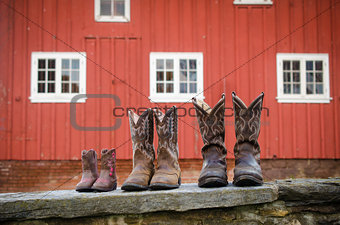 Cowboy Boots in Front of a Red Barn