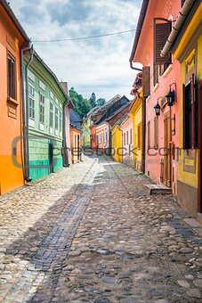 Stone paved old streets with colored houses from Sighisoara fort