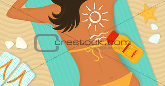 Young girl sunbathes on a beach