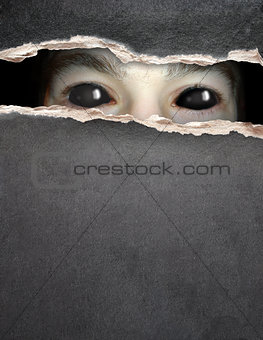 Monster eye in hole in the paper