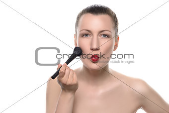 Woman Putting Makeup on Face with Pouting Lips