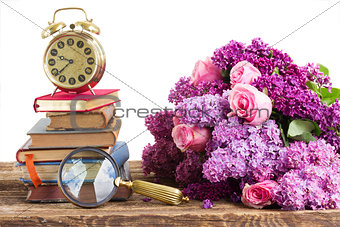 pile of books with clock