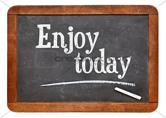 Enjoy today - text on blackboard