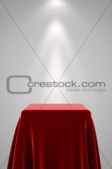 Pedestal with red silk and spot light
