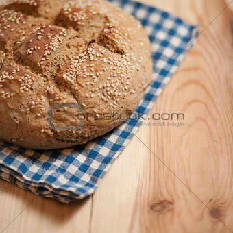 Freshly baked homemade bread on wood background