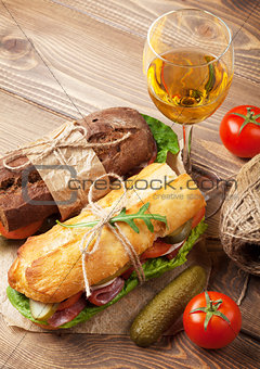 Two sandwiches and white wine glass
