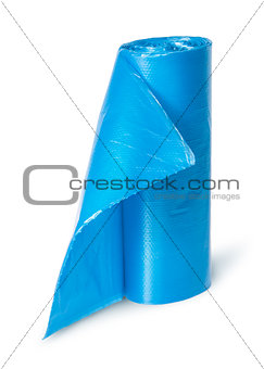 Vertical roll of blue plastic garbage bags