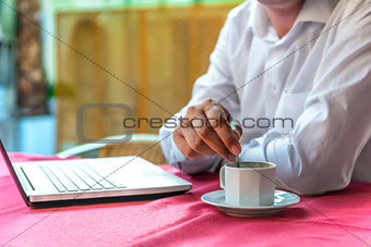 breakfast businessman with a laptop in a cafe