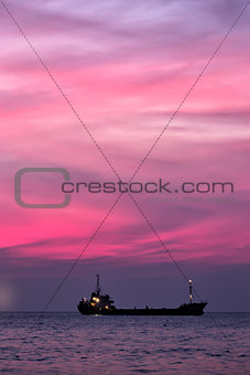 Cargo ship in South China Sea at dusk, Vietnam
