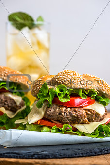 Homemade Hamburger with Fresh Vegetables and Drink with Ice