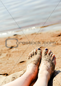 Feet in sand on the beach