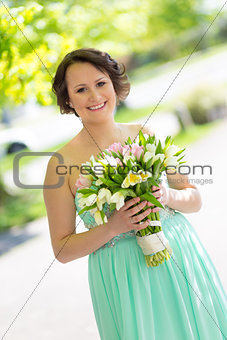 Happy bride with wedding bouquet.