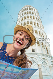Closeup of laughing female tourist holding map in Pisa