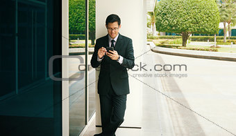 Businessman Writing With Pen On Mobile Phone Display