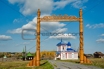 Wooden gate and Rise chapel. Russia
