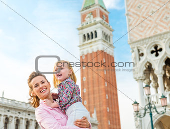 Happy mother and daughter on St. Mark's Square in Venice